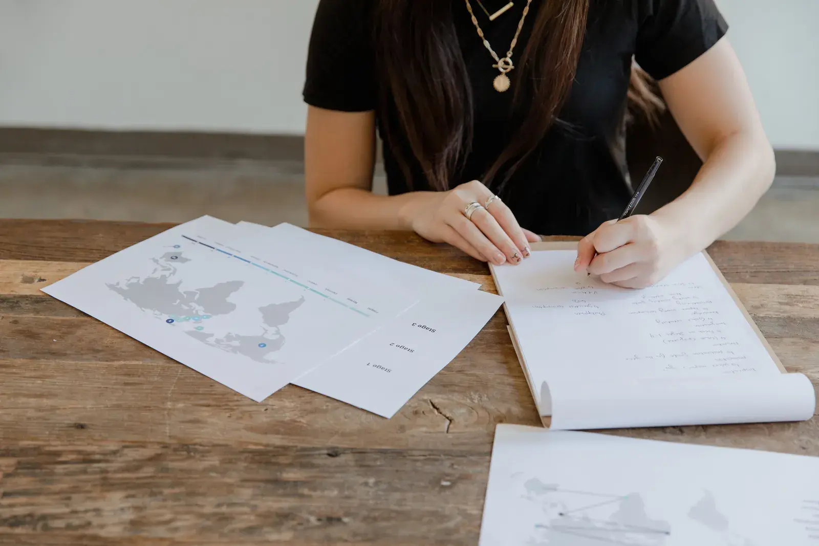 Legal professional reviewing documents and evidence materials at a desk